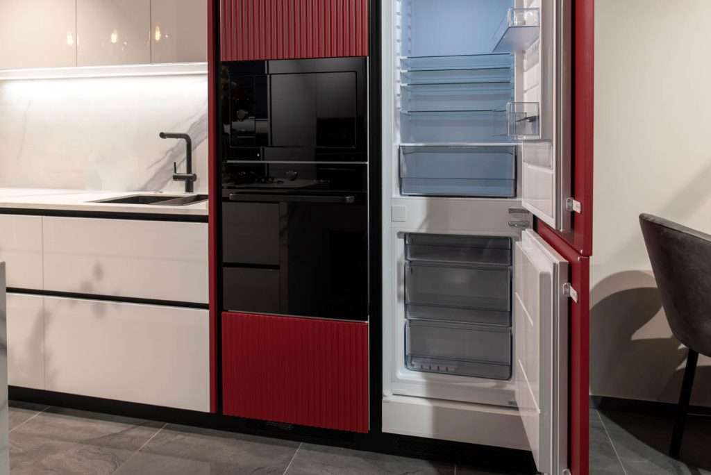 Built-in kitchen appliances with red open doors